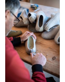 The slippers are cut to size by hand